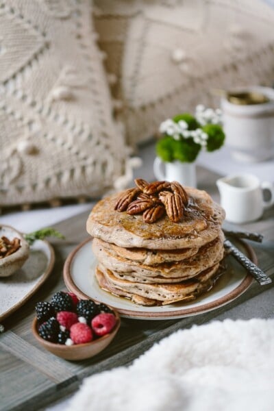 Buckwheat Pancakes Recipe on a bed setting with flours and tea in the background