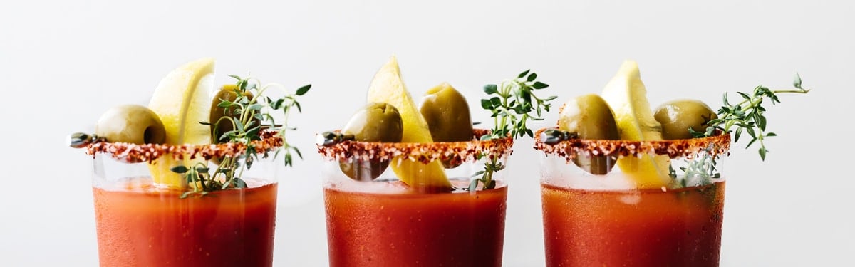 Easy Drink Recipes - Bloody Mary filled glasses garnished with olives and lemon