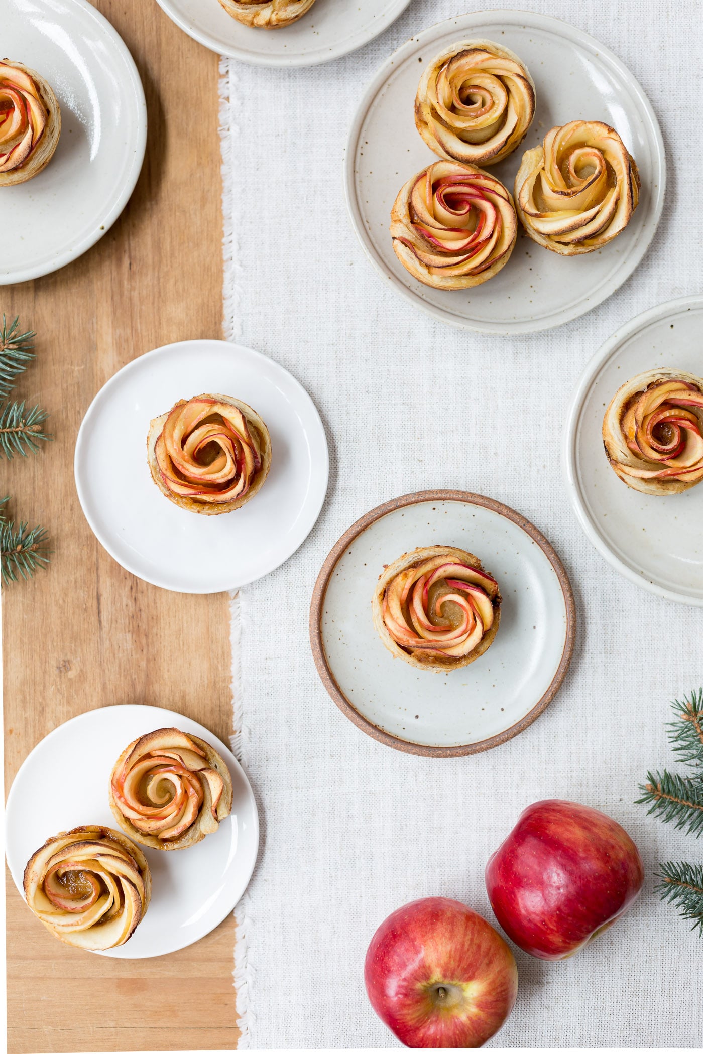How to make puff pastry apple roses - Showcasing freshly baked apple roses served on small plates.