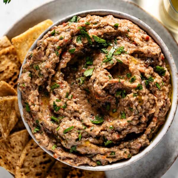 Ina Garten Roasted Eggplant Spread garnished with parsley in a bowl.