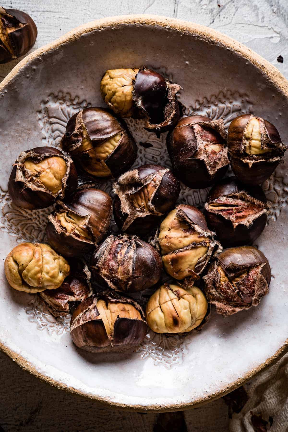 Roasted chestnuts in a bowl from top view