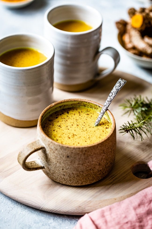 A cup of Vegan Turmeric Golden Milk recipe from the front view