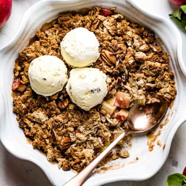 Vegan apple crisp fresh out of the oven topped off with ice cream